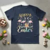 Happy Easter text with three pink flamingos and an Easter basket filled with eggs, on a navy t-shirt