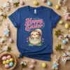 Happy Easter Sloth T-Shirt with a cute sloth in a colorful Easter egg, surrounded by flowers and text