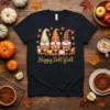 Happy Fall Y'all t-shirt with three gnomes holding pie, pumpkin, and coffee, surrounded by autumn leaves