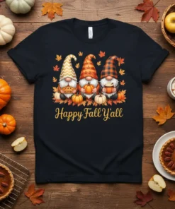 Happy Fall Y'all t-shirt with three gnomes holding pie, pumpkin, and coffee, surrounded by autumn leaves