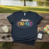 Navy t-shirt with colorful "happy FRI-YAY" text design, featuring retro typography and an oval outline