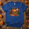 Happy Hallothanksmas text with turkey, pumpkin, and reindeer graphics on a blue t-shirt, featuring Halloween, Thanksgiving, and Christmas elements