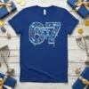 Blue t-shirt with a large '67' design incorporating Star of David, menorahs, dreidels, and gift boxes in blue and silver