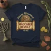 Navy blue t-shirt featuring "Happy Hanukkah Maccabee Revolt 165 BCE" text with a Roman-style coin graphic and scroll design