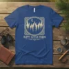 Happy Little Trees text with vintage forest and moon graphic on a blue t-shirt