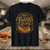 Happy Thanksgiving text with a cornucopia filled with pumpkins, corn, and leaves on a black t-shirt