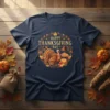 Happy Thanksgiving Day text with a festive turkey, pie, and hat graphic design on a navy blue t-shirt