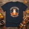 Harvest Blessings Autumn Charms text with a cute cat and pumpkins graphic on a navy t-shirt