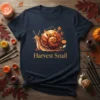 Harvest Snail graphic t-shirt design with a detailed snail surrounded by autumn leaves and pumpkins