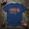 Blue t-shirt with orange text "Hate Us." and a fierce bobcat mascot graphic