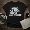 Hating Pop Music Doesn't Make You Deep quote in white glitch text on a black t-shirt, music lover design