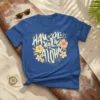 Hau'oli Ka La Aloha text design with hibiscus flowers on a blue t-shirt, Hawaiian vacation theme