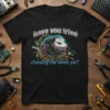 Black t-shirt with text "have you tried chewing the wires yet?" and a possum tangled in colorful wires graphic