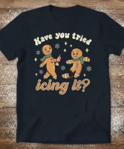 Funny gingerbread cookie pun t-shirt with text "Have you tried icing it?". Features two gingerbread men, one holding icing