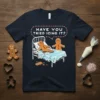 Gingerbread man in bed asking "Have You Tried Icing It?" on a navy t-shirt, humorous holiday design
