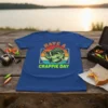 Have A Crappie Day fishing t-shirt with a cool crappie fish wearing sunglasses, vibrant sunset stripes, and fishing gear background