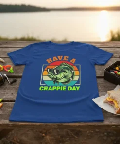 Have A Crappie Day fishing t-shirt with a cool crappie fish wearing sunglasses, vibrant sunset stripes, and fishing gear background