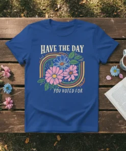 Have The Day You Voted For quote with floral and rainbow graphic on a royal blue t-shirt