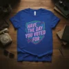 Quote "HAVE THE DAY YOU VOTED FOR" in neon pink and blue on a shield-shaped graphic with circuit board elements