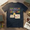 T-shirt design with text "Having Fun Isn't Hard When You've Got A Library Card" and an open book with graphics