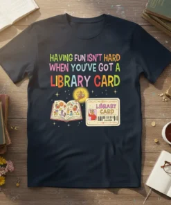 T-shirt design with text "Having Fun Isn't Hard When You've Got A Library Card" and an open book with graphics