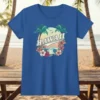 Hawaii text with tropical sunset, palm trees, ocean waves, and hibiscus flowers graphic on a blue t-shirt