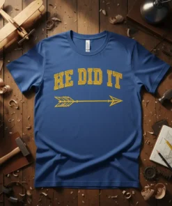 Blue t-shirt with yellow glitter text "HE DID IT" and an arrow graphic