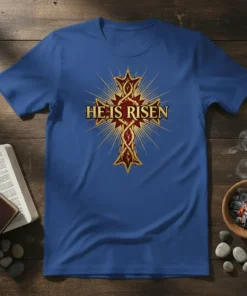 Blue t-shirt with "HE IS RISEN" text in gold and red ornate cross graphic, representing Easter and Christian faith