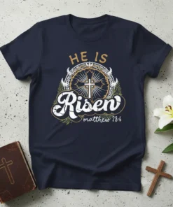 Navy blue t-shirt with "HE IS Risen matthew 28:6" text and a cross surrounded by a crown of thorns graphic
