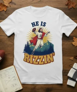 T-shirt with "HE IS RIZIN'" text and Jesus playing football design, religious humor graphic