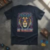 Christian t-shirt with a colorful lion wearing glasses and a crown of thorns, text reads HE IS RIZZIN'