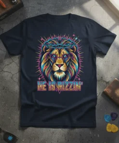 Christian t-shirt with a colorful lion wearing glasses and a crown of thorns, text reads HE IS RIZZIN'