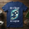 He is Rizzin' HE IS Rizzin' T-Shirt featuring Jesus playing soccer, saving a goal in a blue tee