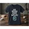 Dark t-shirt with white text "HE NEEDS SOME MILK!" and a glowing milk carton graphic