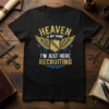T-shirt with "Heaven Is My Home I'm Just Here Recruiting" text and winged shield graphic