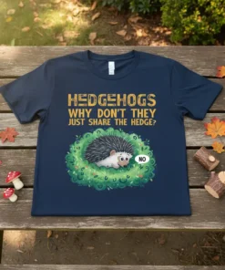 Hedgehogs Why Don't They Just Share The Hedge? quote with a cute hedgehog in a bush on a navy t-shirt