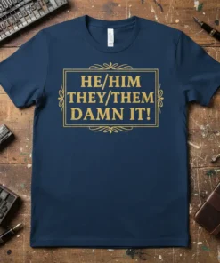 HE/HIM THEY/THEM DAMN IT! text in a golden rectangle on a navy blue t-shirt, promoting pronoun visibility