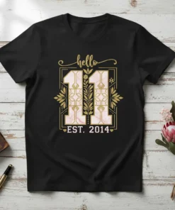 T-shirt with "hello 11 EST. 2014" in elegant gold font, featuring decorative elements and a marble-like number 11