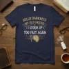 Navy t-shirt with gold text "Hello Darkness My Old Friend I Stood Up Too Fast Again" and a melting clock