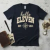 Navy blue t-shirt with "hello ELEVEN EST. 2014" in distressed cream font and a compass graphic