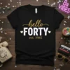 Black t-shirt with "hello FORTY est. 1985" design in gold and white font, featuring small heart accents