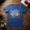 Hello Second Grade text with a tie-dye pencil graphic featuring a heart, on a blue t-shirt
