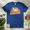 Hello Sunshine text with a radiant sun graphic on a blue t-shirt, perfect for summer