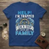 HELP! I'M TRAPPED ON A SHIP WITH MY FAMILY text and ship wheel graphic on a blue t-shirt