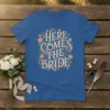 Here Comes The Bride text design with floral and diamond accents on a blue t-shirt