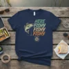 Navy t-shirt with "HERE FISHY FISHY FISHY" text and a fish graphic, styled with fishing gear
