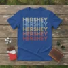 Retro HERSHEY HERSHEY HERSHEY HERSHEY HERSHEY text design in multiple colors on a royal blue t-shirt