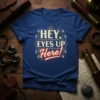 HEY, EYES UP Here! text design with decorative arrows and lines on a blue t-shirt