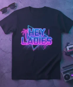 Black t-shirt with "HEY LADIES" text in neon pink and blue, featuring a palm tree and retro grid design