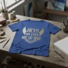HEY!! MY EYES ARE UP HERE text with golden wings and eye graphic on a blue t-shirt